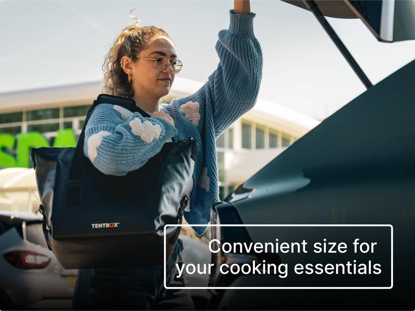 Person carrying the black TentBox CoolBag from the supermarket to the car boot, with text 'Convenient size for your cooking essentials'.