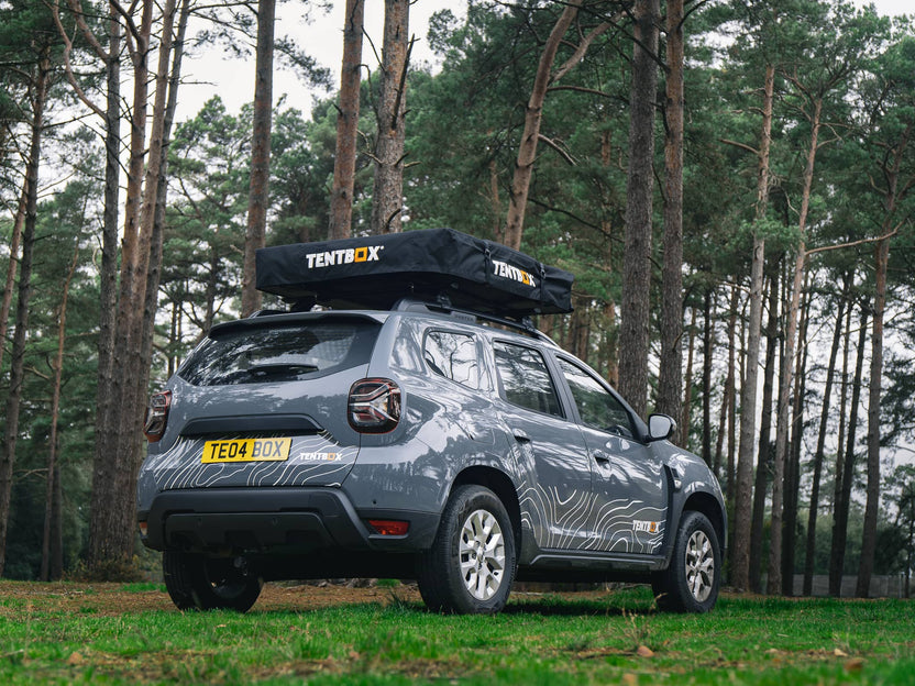 ATCLI - TentBox Lite 1.0 Travel Cover installed on a grey car in the woods